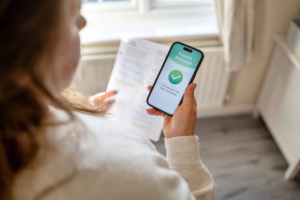 Bills are paid efficiently using the mobile banking app on your smartphone while keeping a paper invoice at home. Household expenses a Bills are paid efficiently using the mobile banking app on your smartphone while keeping a paper invoice at home. Household expenses a