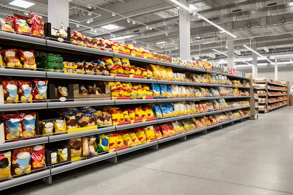 The supermarket area is full of packaged foods that are delicately placed on the shelves