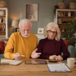 Senior couple planning retirement with a tablet computer