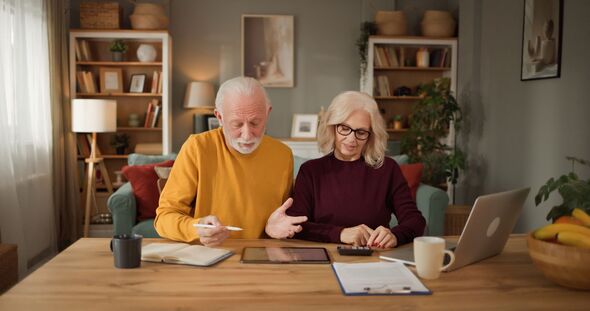 Senior couple planning retirement with a tablet computer