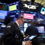 Traders work on the floor of the NYSE in New York