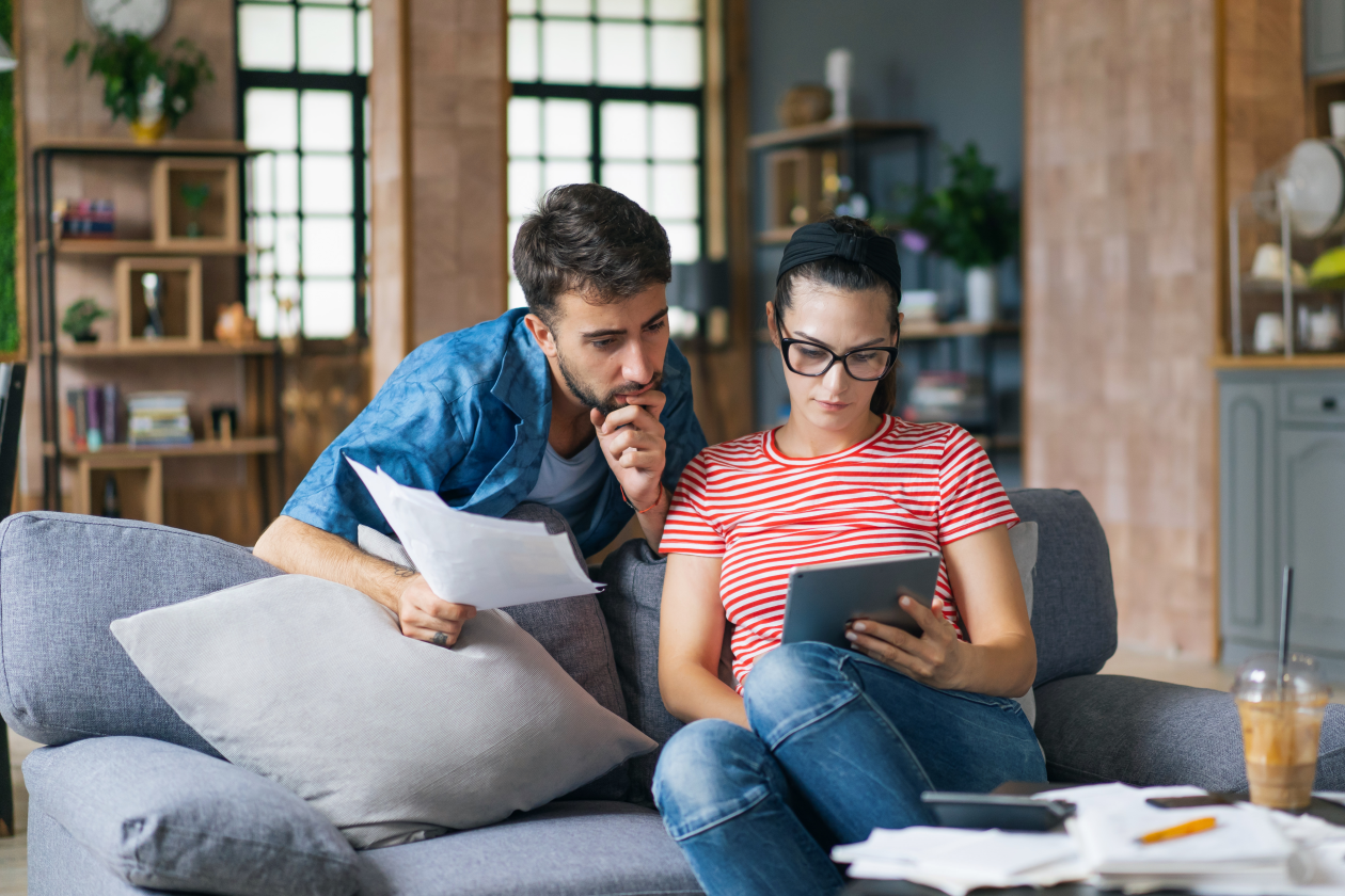 Couple checking their bank account and bills.png
