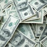 A loose collection of 100 dollar bills.